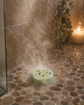 Pampering Bar aromatherapy shower steamer in use on a wet shower floor