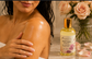Woman applying Pampering Bar hydrating body oil to her arm for soft moisturized skin